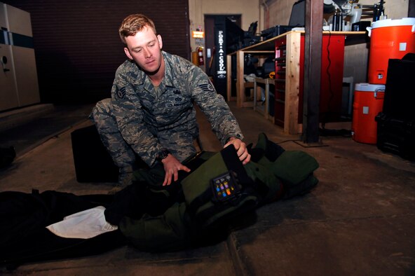 Staff Sgt. Andrew Trelly, 51st Civil Engineer Squadron explosive ordnance disposal team leader, inspects his gear in Bldg. 646 at Osan Air Base, Republic of Korea, April 28, 2014. Trelly is this week’s Airman Spotlight winner. (U.S. Air Force photo/Senior Airman David Owsianka)