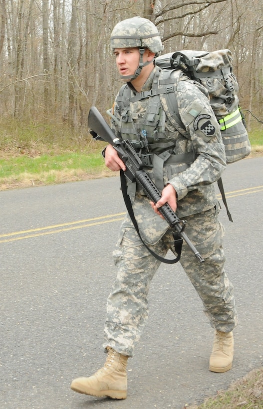 Army Spc. Joshua Meyer, a college student in civilian life and a trumpet player with the Army Reserve’s 198th Army Band, participates in the road march event as part of the Best Warrior Competition at Joint Base McGuire-Dix-Lakehurst, N.J., April 23, 2014. U.S. Army photo by Sgt. Salvatore Ottaviano