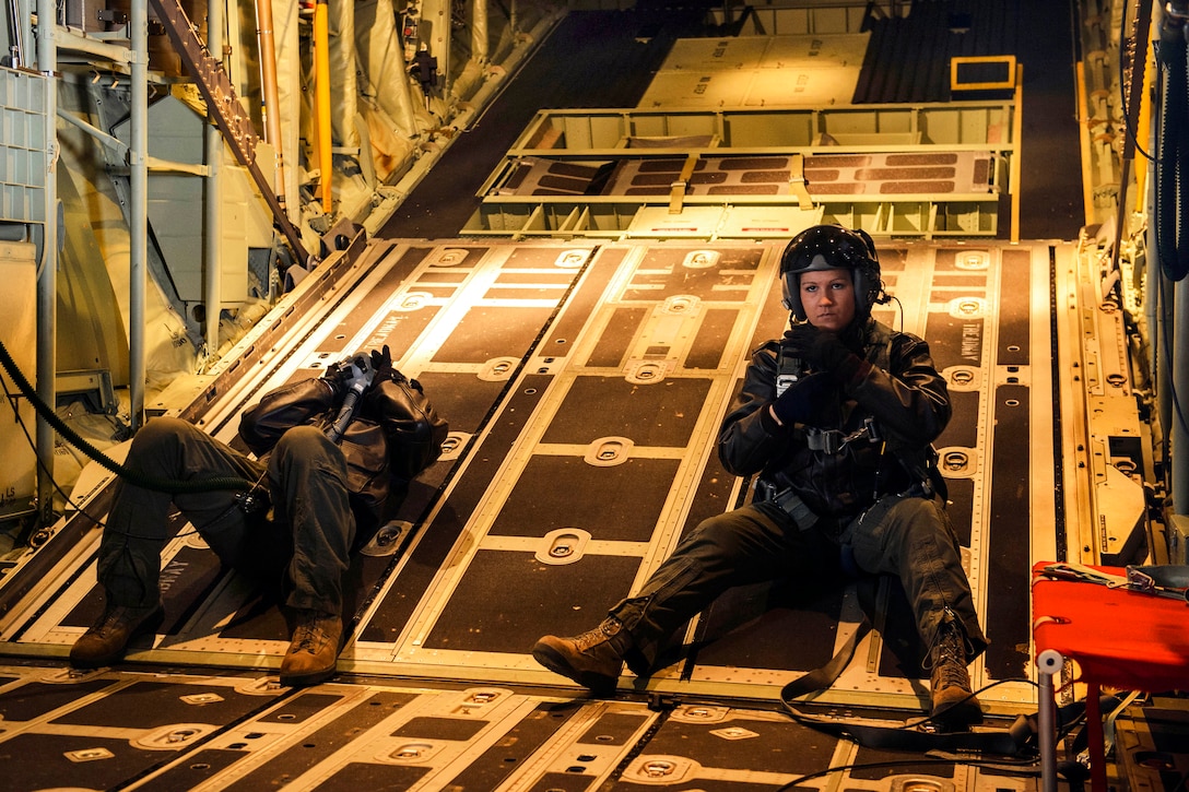 Air Force Airman 1st Class Shelby Duncan, right, and Senior Airman Jamie Richardson-Granger prepare for Army Special Forces soldiers to conduct a high-altitude, low opening jump from a C-130J Super Hercules aircraft over Yakima Training Center, Wash., April 23, 2014.