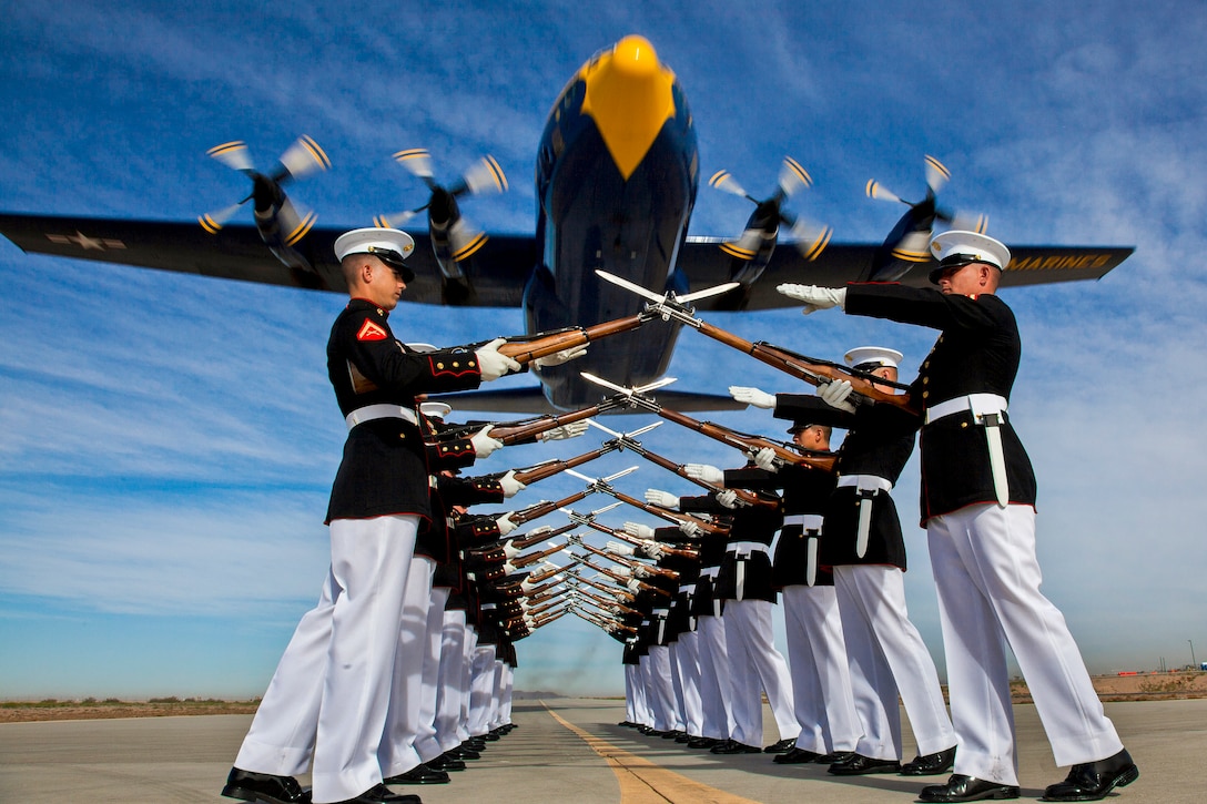 The Blue Angels’ C-130 Hercules, affectionately known as "Fat Albert," flies over the Silent Drill Platoon on Marine Corps Air Station Yuma, Ariz., March 4, 2014. The Marine Corps pilots who fly the C-130 must be aircraft commander qualified with at least 1,200 flight hours. 