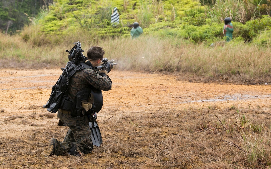 Marines dive toward objective during beach reconnaissance training