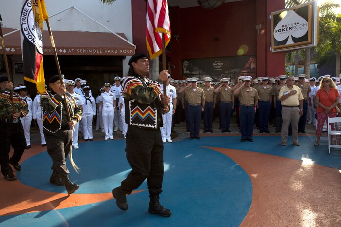 U.S. Marines and Sailors salute as the Seminole Tribe of Florida Color Guardsmen march to the colors during a welcoming party for participants of Fleet Week Port Everglades 2014 from South Florida local community leaders at the Seminole Hard Rock Hotel and Casino in Fort Lauderdale, Fla., April 28. Approximately 120 Marines from 2nd Assault Amphibian Battalion, 2nd Battalion, 6th Marine Regiment, 2nd Marine Division, Marine Corps Base Camp Lejeune, N.C., and Marine Light Attack Helicopter Squadron (HMLA) 269, Marine Corps Air Station New River, N.C., embarked aboard the USS New York (LPD 21) and are participating in the 24th Annual Fleet Week in Port Everglades; South Florida’s annual celebration of maritime forces. (U.S. Marine Corps photo by Sgt. Alicia R. Leaders/Released)