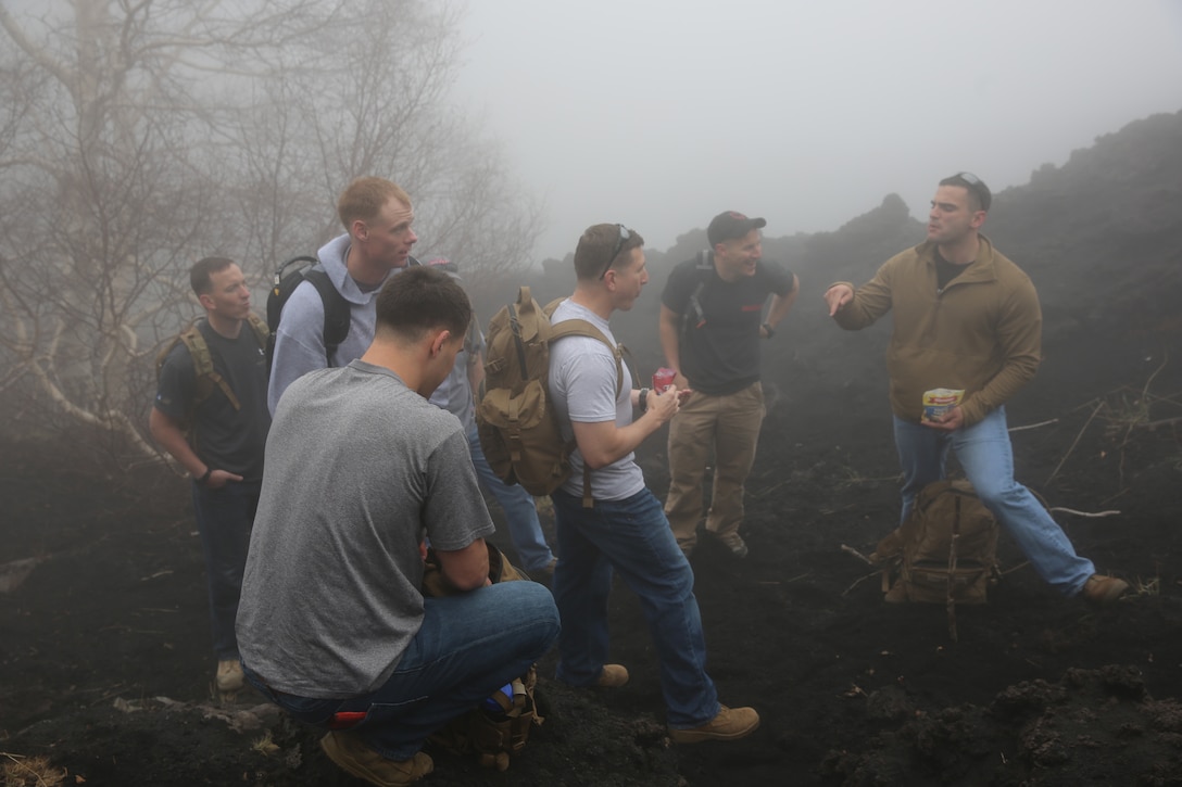 Marines with Special-Purpose Marine Air-Ground Task Force 14 Africa take a break during hike up a trail on Mt. Etna, Italy, April 26, 2014. The service members hiked up the volcano in observance of Earth Day.