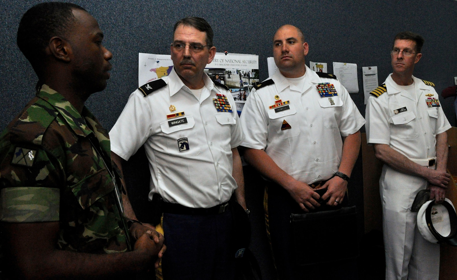 Col. Dallas Wingate, Sgt. Donald Powell and Capt. Phil Fowler receive an overview April 10, 2014, on the Operation of Disaster Preparedness and Management's radio room from a member of the Trinidad and Tobago Defence Force. 
