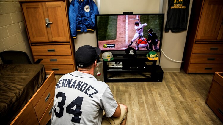 Sergeant Kristopher Golden, radio chief, 15th Marine Expeditionary Unit, watches Kyle Seager, infielder, Seattle Mariners, hit a three-run, walk-off home run in the ninth inning against the Houston Astros from his room aboard Camp Pendleton, Calif., April 23, 2014. Golden, Golden, 27, is from Lacey, Wash.