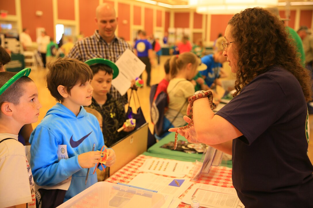 Students from Berkley Manor and Heroes Elementary schools learn about wildlife aboard the base from Diana Rashash, extension area specialized agent from the North Carolina Cooperative Extension Service, at the annual Earth Day Exposition at Marston Pavilion aboard Marine Corps Base Camp Lejeune, April 24. Environmental Management Division aboard base hosted the expo to encourage service members, families and students to learn more about Earth Day and how they can protect the environment.