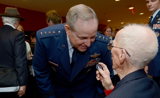 Air Force Chief of Staff Gen. Mark A. Welsh III congratulates 1st Lt. James Mahon after awarding him the Prisoner of War Medal during a ceremony April 30, 2014, at the Pentagon. Mahon and eight fellow World War II aviators, all bomber crew members, were shot down flying missions over Germany and were held in a prison camp in Wauwilermoos, Switzerland. The men were originally denied POW status. U.S. Army Maj. Dwight Mears, whose grandfather Lt. George Mears, who was held at the prison, fought diligently for 15 years to get the men recognized as POWs. (U.S. Air Force photo/Scott M. Ash)           