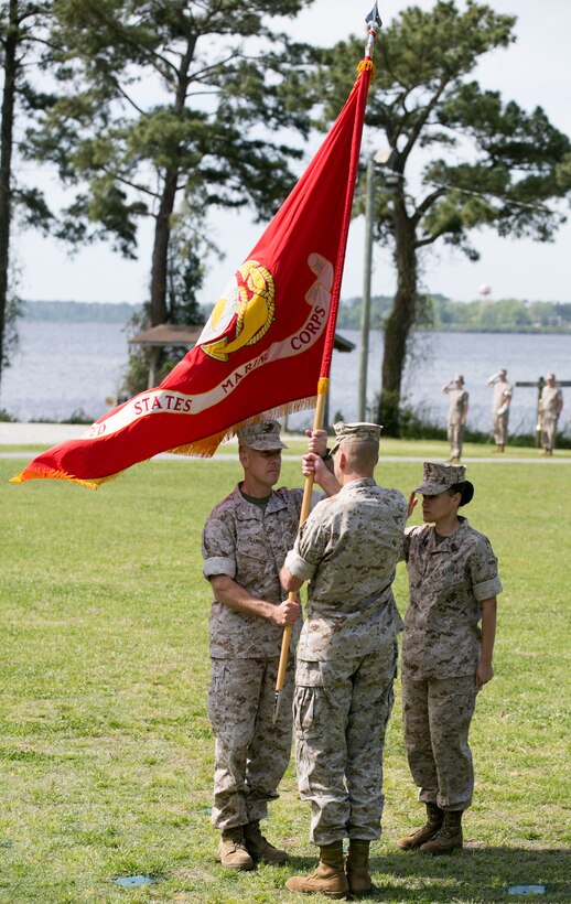 Lt. Col. Paul Fillmore (left), the incoming commanding officer of Personnel Administration School, receives the unit colors and assumes command from Lt. Col. Charles Winchester, the outgoing commanding officer of PA School, during a change of command ceremony aboard Marine Corps Base Camp Johnson, April 17.