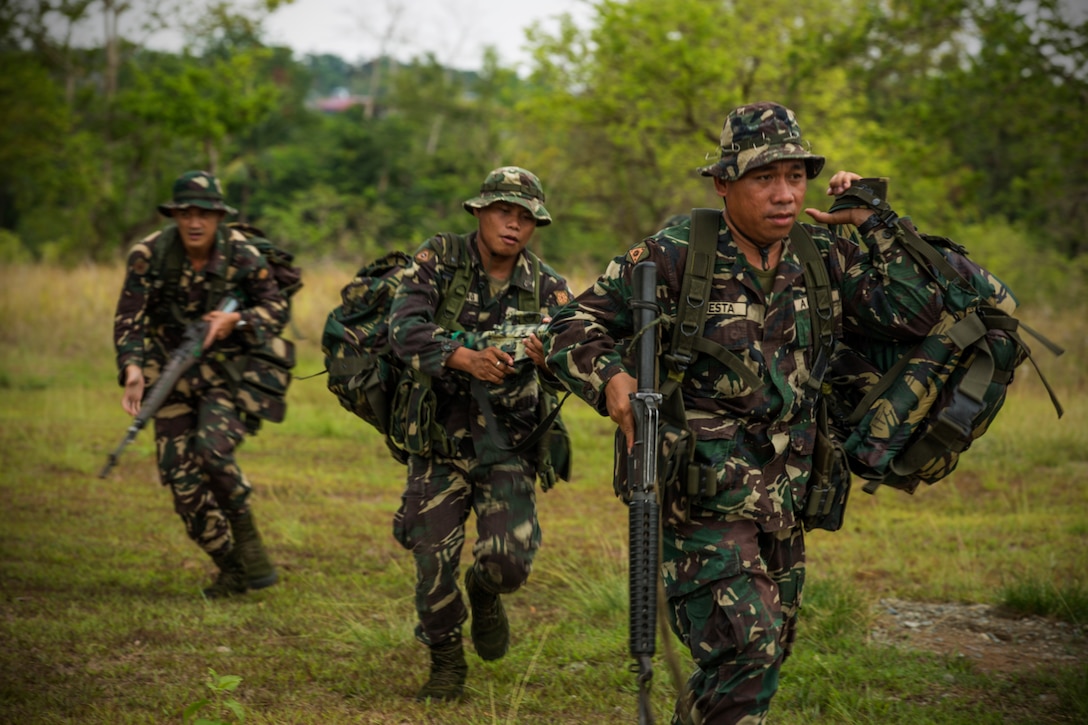 Philippines Army Soldiers leave a notional landing zone during helicopter insert and extract training with U.S. Army Soldiers on Fort Magsaysay, Philippines, April 29, 2014. Philippine and U.S. Army personnel are preparing for an upcoming field training exercise during Balikatan 2014. This year marks the 30th iteration of the exercise, which is an annual Republic of the Philippines-U.S. military bilateral training exercise and humanitarian civic assistance engagement.