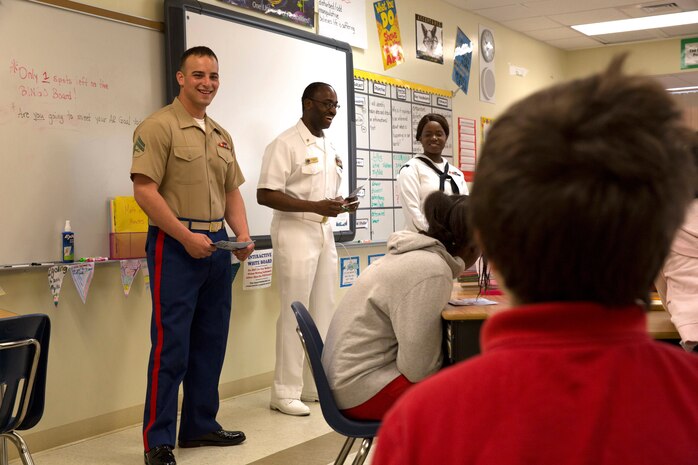 Skyler K. Becker, fourth grader of Harbordale Elementary School in Fort Lauderdale, Fla., asks a question about the military to Cpl. Joel A. Slaymaker, native of Lancaster, Penn., and amphibious assault crewman with 2nd Assault Amphibian Battalion, 2nd Marine Division, Marine Corps Base Camp Lejeune, N.C., during a school visit to Harbordale Elementary School in Fort Lauderdale, Fla., April 30, as part of a community relations event of Fleet Week Port Everglades 2014. Three Marines from 2nd AAV Bn., and 2nd Battalion, 6th Marine Regiment, 2nd Marine Division, as well as Sailors from the USS New York (LPD 21) and Carrier Strike Group 12 spoke to more than 450 Harbordale Elementary students about their experiences in the military and on ship. (U.S. Marine Corps photo by Sgt. Alicia R. Leaders/Released)