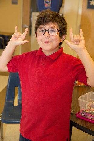 Skyler K. Becker, fourth grader of Harbordale Elementary School in Fort Lauderdale, Fla.,poses for a photo when Marines and Sailors visited Harbordale Elementary School in Fort Lauderdale, Fla., April 30, as part of a community relations event of Fleet Week Port Everglades 2014. Three Marines from 2nd AAV Bn., and 2nd Battalion, 6th Marine Regiment, 2nd Marine Division, as well as Sailors from the USS New York (LPD 21) and Carrier Strike Group 12 spoke to more than 450 Harbordale Elementary students about their experiences in the military and on ship. (U.S. Marine Corps photo by Sgt. Alicia R. Leaders/Released)