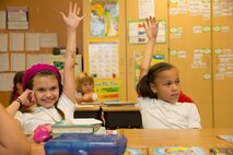 (From left) Michaela Z. Lovejoy, and Cameron L. Houston, both second graders of Harbordale Elementary School in Fort Lauderdale, Fla.,raise their hands to ask Marines and Sailors questions furing a school visit to Harbordale Elementary School in Fort Lauderdale, Fla., April 30, as part of a community relations event of Fleet Week Port Everglades 2014. Three Marines from 2nd Assault Amphibian Battalion, and 2nd Battalion, 6th Marine Regiment, 2nd Marine Division, as well as Sailors from the USS New York (LPD 21) and Carrier Strike Group 12 spoke to more than 450 Harbordale Elementary students about their experiences in the military and on ship. (U.S. Marine Corps photo by Sgt. Alicia R. Leaders/Released)