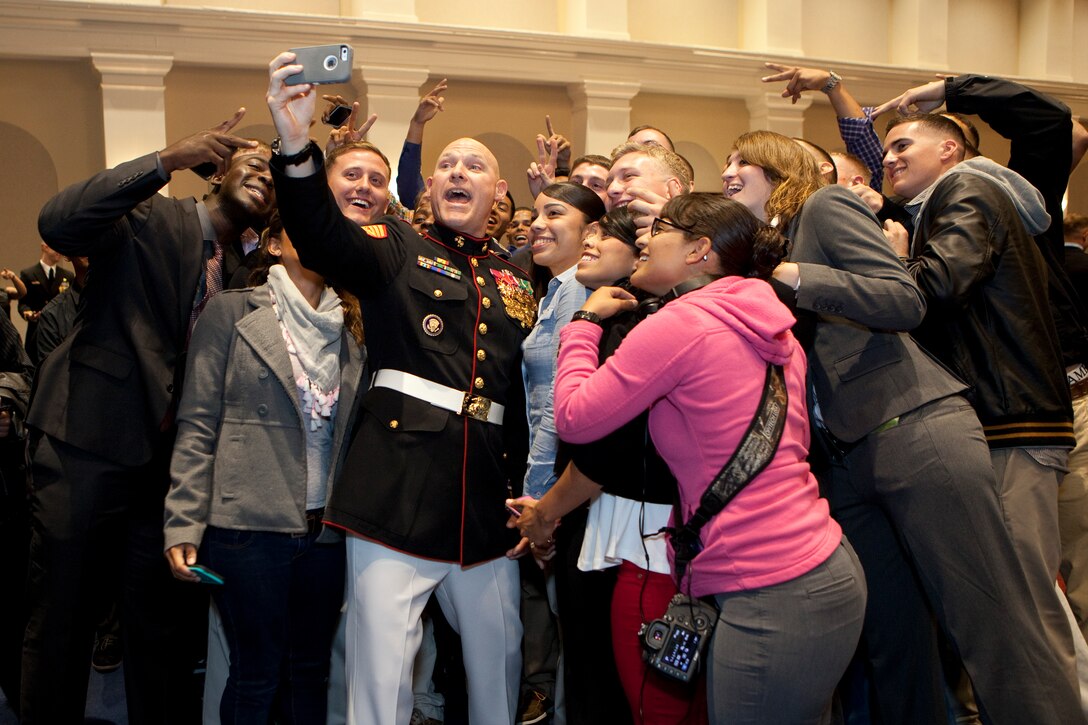 Sgt. Maj. Micheal P. Barrett, the 17th Sergeant Major of the Marine Corps, greets friends and family members of Marines assigned to the Marine Barracks Washington, D.C., at the reception for the first evening parade of the year on April 25, 2014. (U.S. Marine Corps photo by Sgt. Marionne T. Mangrum)