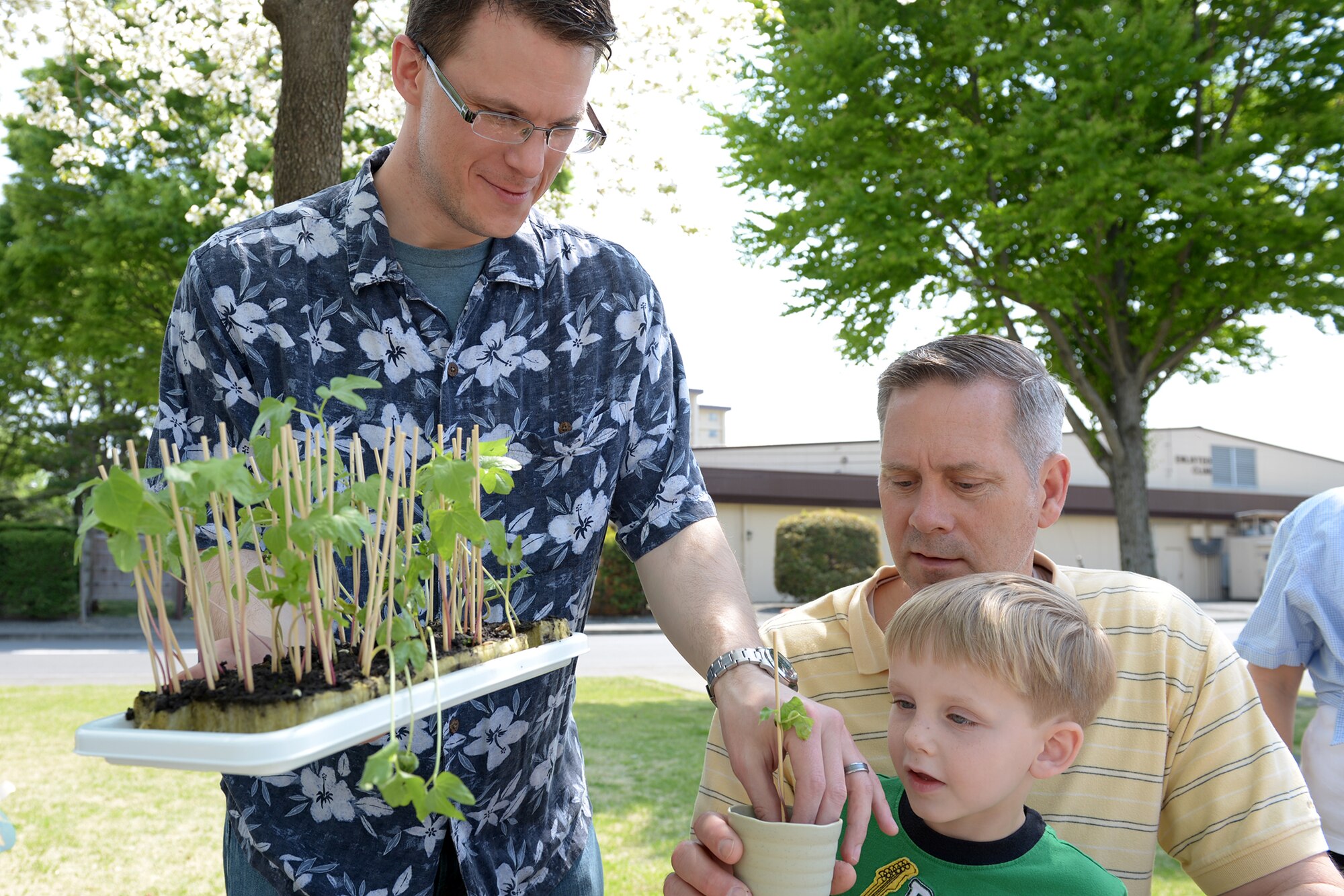 Samuel Richards, 374th Force Support Squadron library director, distributes morning glory seedlings at Yokota Air Base, Japan, April 26, 2014. Children were educated by volunteers about plant care and recycling as part of the Earth Week event. (U.S. Air Force photo by Airman 1st Class David Danford/Released)