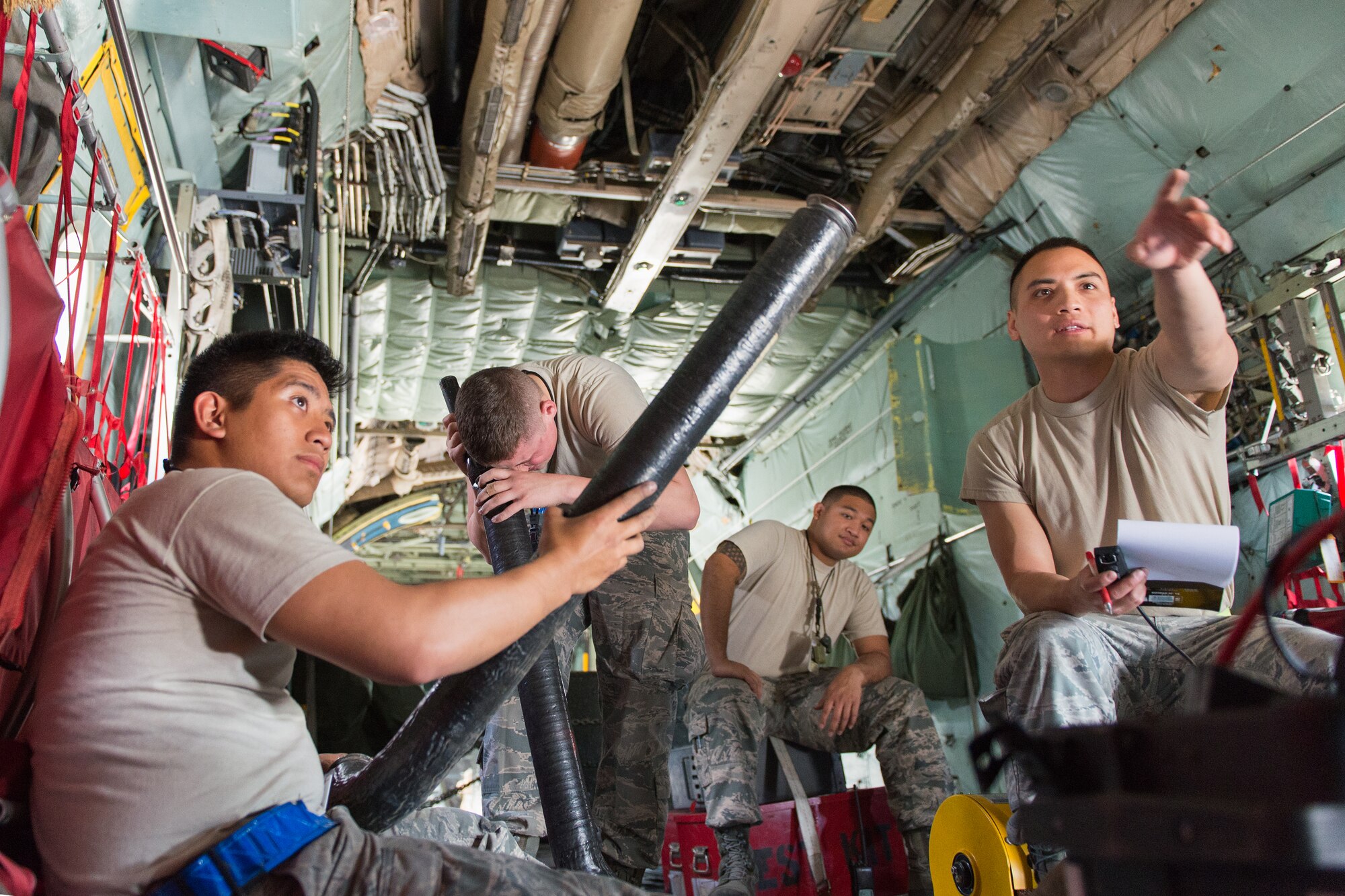 Airmen from the 374th Aircraft Maintenance Squadron electric and environmental shop use a borescope to inspect inside parts of a C-130 at Yokota Air Base, Japan, April 28, 2014.  The borescope consists of a miniature video camera on the end of a flexible tube that projects the image on a screen, allowing Airmen to inspect deep within equipment, engines and other dark spaces. (U.S. Air Force photo by Osakabe Yasuo/Released) 