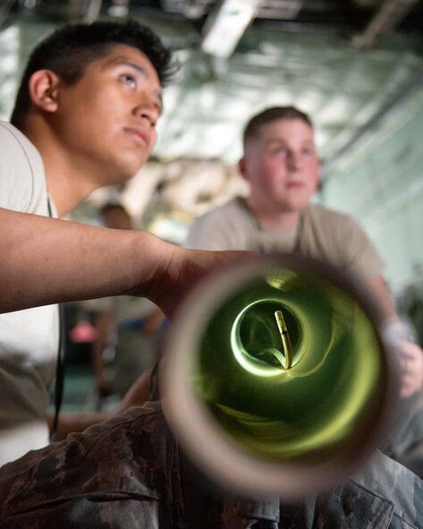 (Right to left) Airmen 1st Class Alexander Buenviaje and Nathan Judd, both from the 374th Aircraft Maintenance Squadron electrical and environmental shop,monitor a video borescope view screen to inspect parts of a C-130 Hercules at Yokota Air Base, Japan, April 28, 2014.  Yokota maintainers spend their time troubleshooting maintenance issues on the flightline and conducting daily maintenance on the aircraft. (U.S. Air Force photo by Osakabe Yasuo/Released)