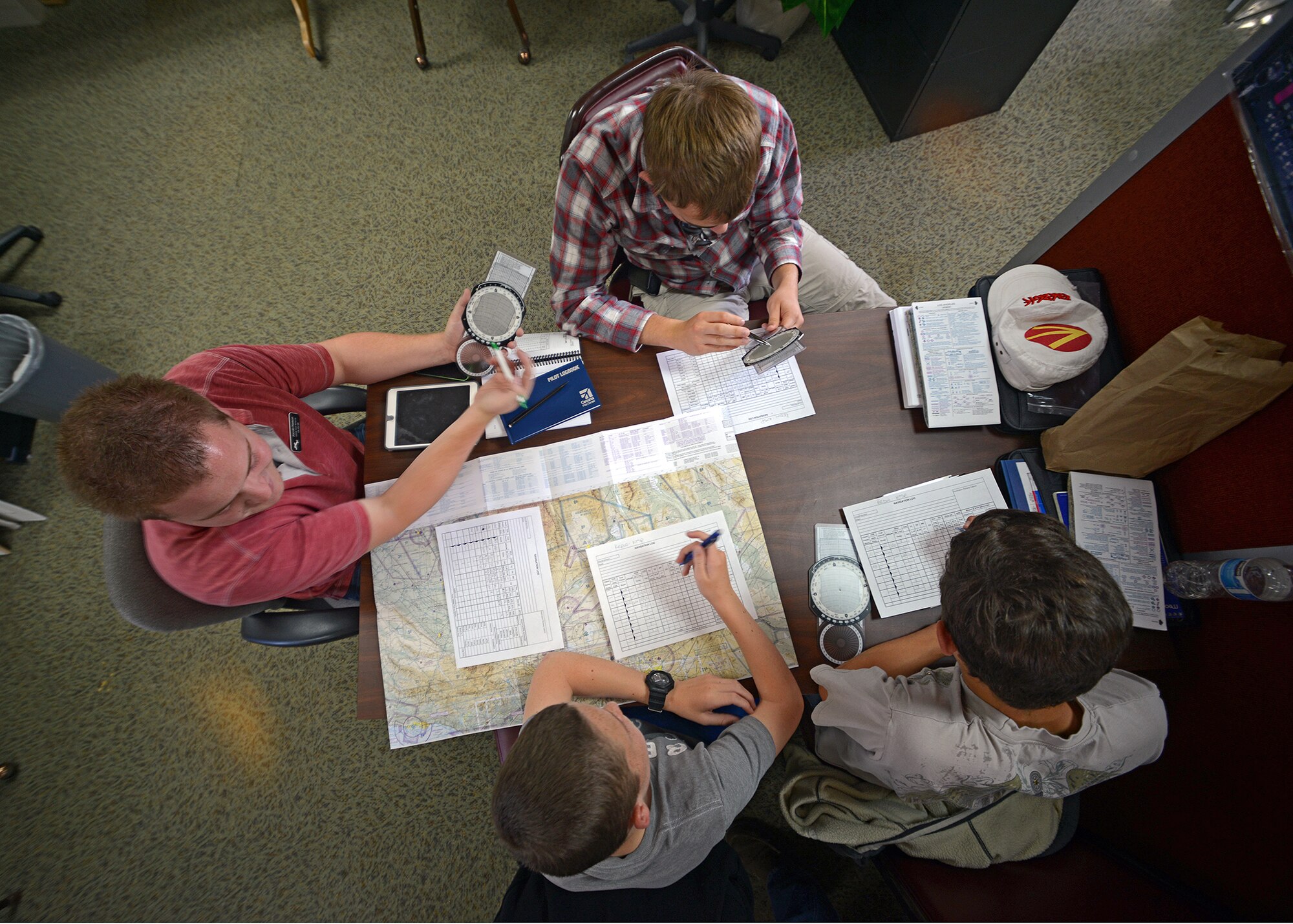 Jacob Nelson (far left), Aero Club certified flight instructor, teaches Aero Camp students how to file a flight plan April 22, prior to their departure to Tehachapi, Calif. This year's second annual Aero Camp was held April 21 to 25, and is intended to train students, ages 14 to 19, with the help of certified flight instructors in order to start flight and ground school training. The second camp is scheduled for late July.(U.S. Air Force photo by Jet Fabara)