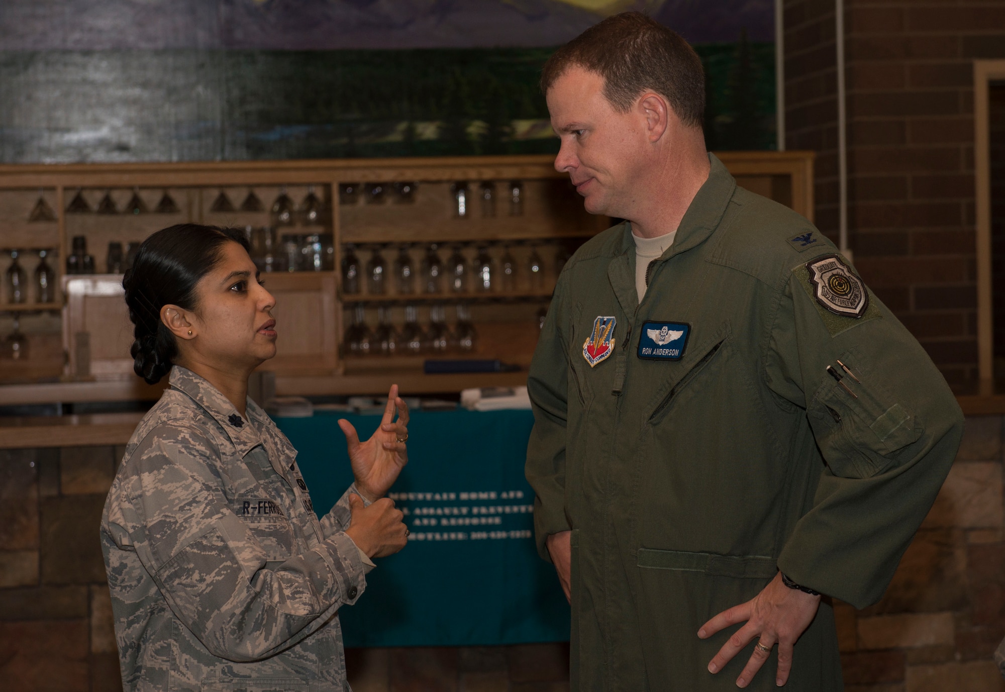 Col. Byron Anderson, 366th Fighter Wing vice commander, speaks with Lt. Col. Andrea R-Ferreli, 366th Fighter Wing judge advocate, during the Sexual Assault Prevention and Response breakfast at Mountain Home Air Force Base, Idaho April 23, 2014. Chaplain (Lt. Col.) Patrick Genseal, 366th Fighter Wing, was the guest speaker. (U.S. Air Force photo by Airman 1st Class Malissa Lott/RELEASED)