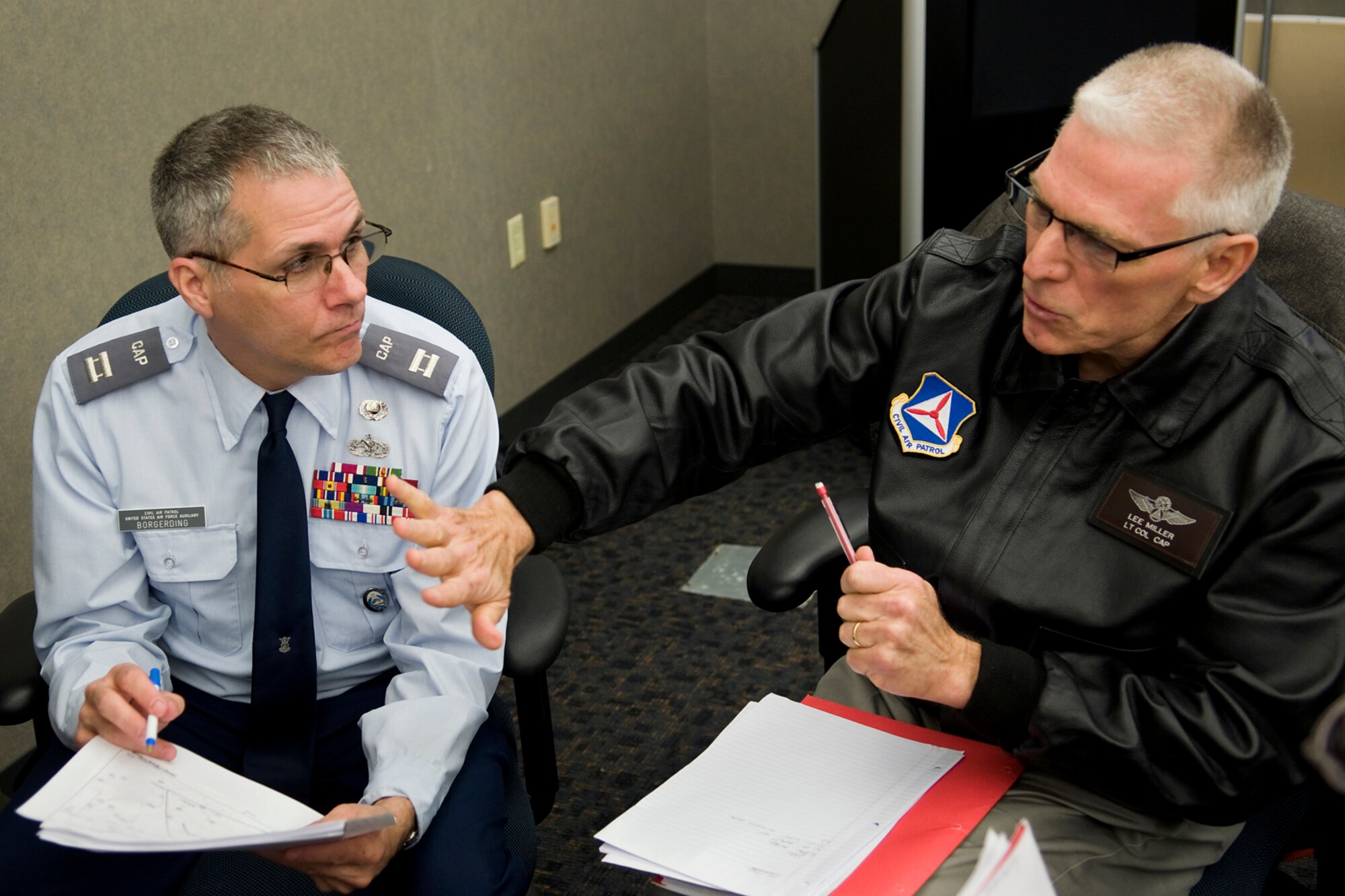 Civil Air Patrol Capt. Richard Borgerding, Don Gentile Composite Squadron 709, Piqua, Ohio, and Lt. Col. Lee Miller, the CAP's Michigan Wing emergency services officer, discuss incident response procedures during an incident command system training course at Grissom Air Reserve Base, Ind., April 3, 2014. CAP officers from around the Great Lakes Region, which encompasses Indiana, Illinois, Kentucky, Michigan, Ohio and Wisconsin, came to Grissom to take part in a special training course meant to improve the CAP's  operational capabilities. (U.S. Air Force photo/Tech. Sgt. Mark R. W. Orders-Woempner)
