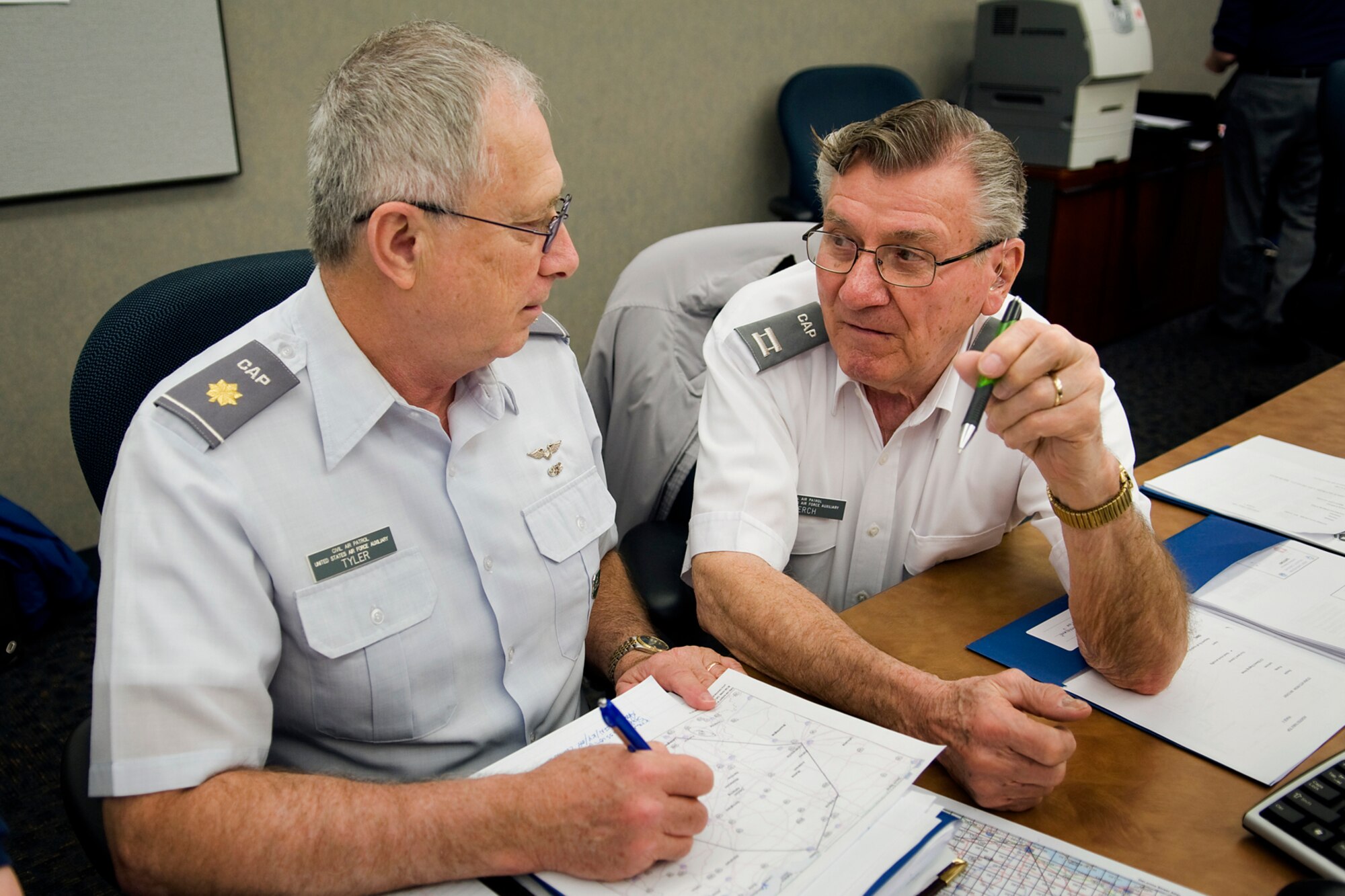 Civil Air Patrol Maj. Mark Tyler, an incident commander for the CAP's Indiana Wing, and CAP Capt. Norbert Kerch, assigned to the CAP's Frank H. Kettlewood Composite Squadron, Painesville, Ohio, discuss incident response procedures during an incident command system training course at Grissom Air Reserve Base, Ind., April 3, 2014. CAP officers from around the Great Lakes Region, which encompasses Indiana, Illinois, Kentucky, Michigan, Ohio and Wisconsin, came to Grissom to take part in a special training course meant to improve the CAP's  operational capabilities. (U.S. Air Force photo/Tech. Sgt. Mark R. W. Orders-Woempner)
