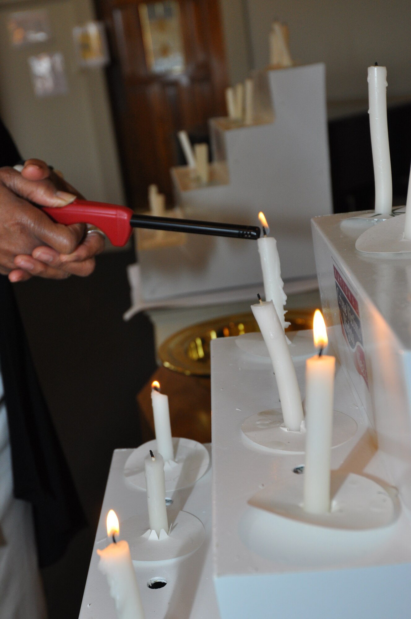Ms. Evelyn Mickles, 301st Fighter Wing's Domestic Abuse Victim Advocate, begins the tradition of lighting a candle for those victims affect by a criminal tragedy in the 5th Annual Candlelight Vigil the Naval Air Station Fort Worth Joint Reserve Base, Texas. (U.S. Air Force photo/Master Sgt. Julie Briden-Garcia)