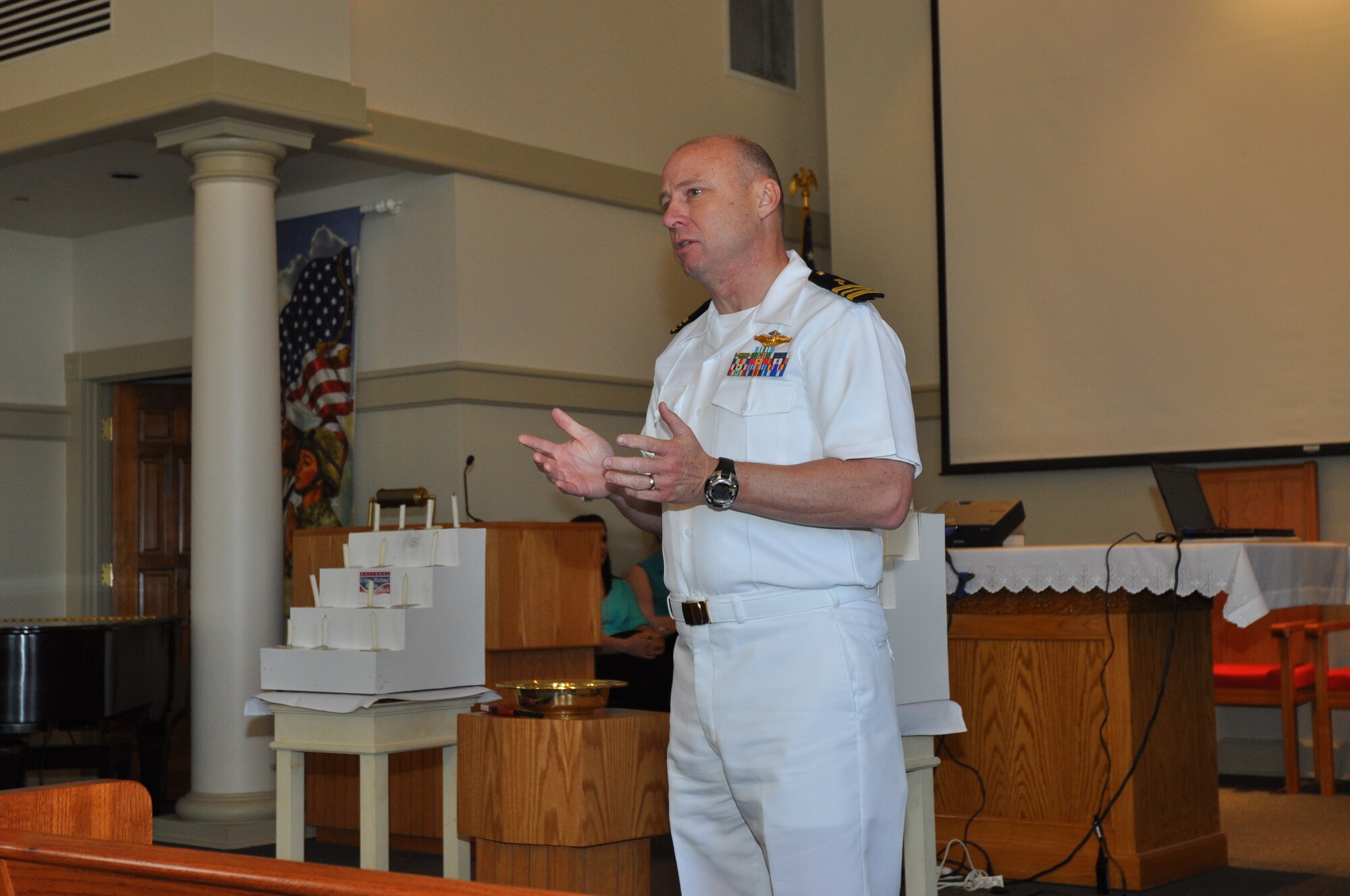 At the Naval Air Station Fort Worth Joint Reserve Base, Texas, Chaplain (Lt. Cmdr.) Marcus Lawrence addressed the audience during the 5th Annual Candlelight Vigil at the base chapel. (U.S. Air Force photo/Master Sgt. Julie Briden-Garcia)