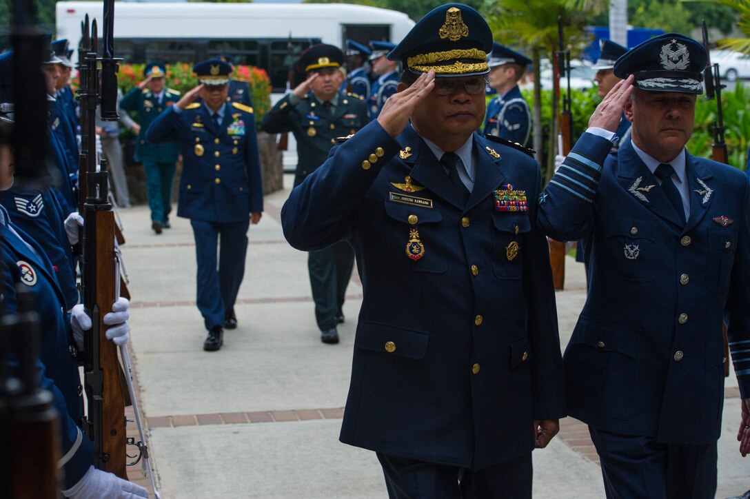 Attendees of the 2014 Pacific Air Chiefs' Symposium march through an honor guard cordon outside the Pacific Air Forces Headquarters building March 29, 2014, at Joint Base Pearl Harbor-Hickam, Hawaii before traveling to Washington, D.C. (U.S. Air Force photo by Staff Sgt. Nathan Allen/released)