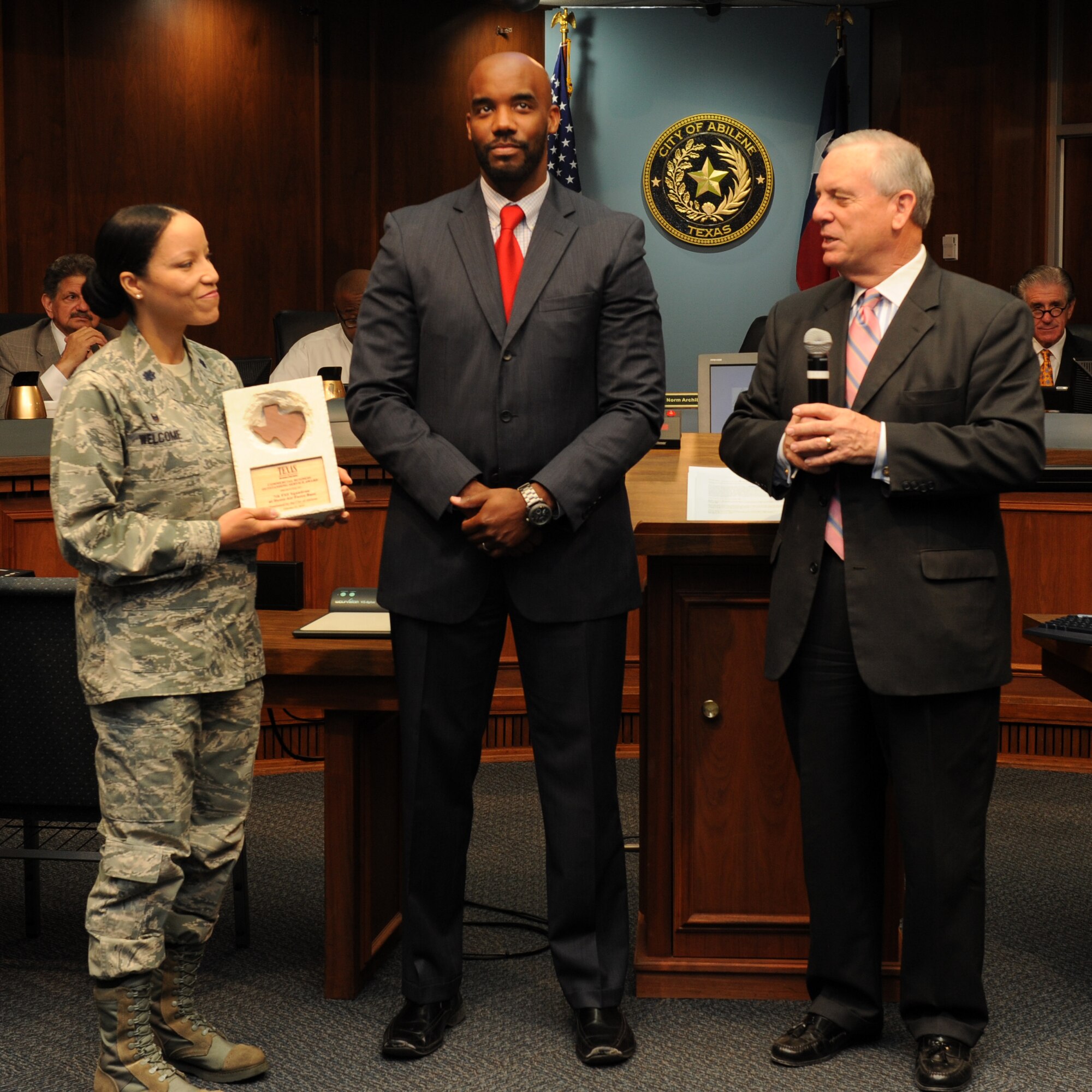 From left, U.S. Air Force Lt. Col. Naomi Welcome, 7th Force Support Squadron commander, accepts the Texas Recreation and Park Society Commercial Business Outstanding Service Award from James Childers, Abilene director of community service, and Norm Archibald, Mayor of Abilene, April 24, 2014, in Abilene, Texas. The award was given to the 7th FSS to recognize their contributions to an annual dinner that takes place at the South Park Recreation Center. (U.S. Air Force photo by Airman 1st Class Autumn Velez/Released)