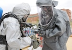 Army Sgt. 1st Class Marcia Hento (left) rehearses the process of decontaminating a camera used by Air Force
Tech. Sgt. Dustin Clement, both members of the South Dakota National Guard’s 82nd Civil Support Team,
during a training exercise April 22 at Camp Rapid in Rapid City, S.D. The exercise, facilitated by U.S. Army
North’s Civil Support Training Activity, is designed to test the unit’s ability to respond to a chemical, biological,
radiological or nuclear incident. The CSTA is based out of Joint Base San Antonio-Fort Sam Houston.