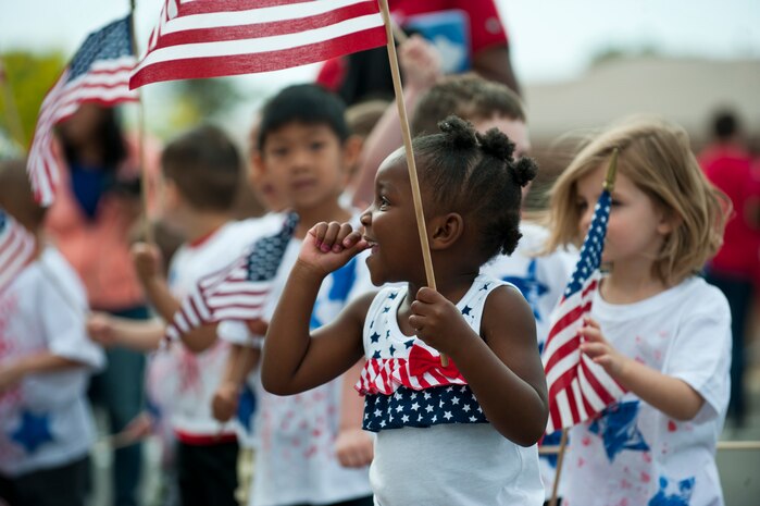 Jada Dixson marches with her classmates in the Month of the Military Child parade in front of the Child Development Center April 25, 2014, at Nellis AFB, Nev. Month of the Military Child is celebrated all throughout April. Every day of the week throughout April, there is a different theme to help celebrate the Month of the Military Child. Some of the themes include, crazy hat day, pajama day and crazy hair day. (U.S. Air Force photo by Airman 1st Class Thomas Spangler)