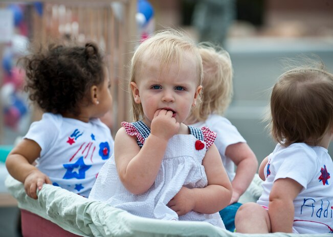 Lydia, daughter of Staff Sgt. Christopher, 432nd Operations Support Squadron weather forecaster, participates in the Month of the Military Child parade in front of the Child Development Center April 25, 2014, at Nellis AFB, Nev. The Month of the Military Child parade is done to celebrate children in military families and recognize the challenges they face with being in a military family. (U.S. Air Force photo by Airman 1st Class Thomas Spangler)