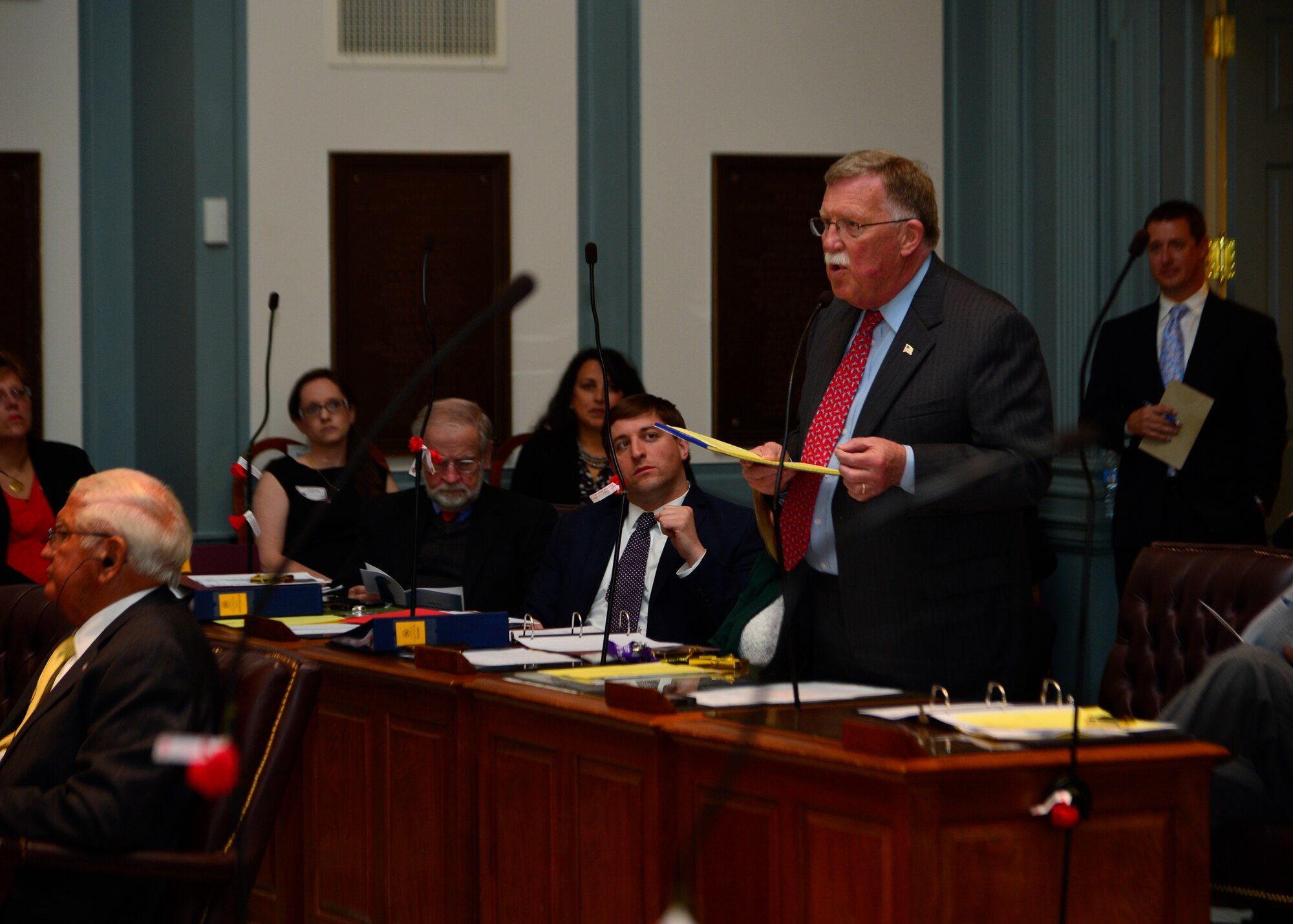 Brian Bushweller, Delaware State Senator, speaks to the state senate about the sacrifices made by military children April 29, 2014, on the senate floor in Dover, Del. The state senate passed a resolution to make April 30, 2014, a day of recognition of the military child. (U.S. Air Force photo/Airman 1st Class William Johnson)