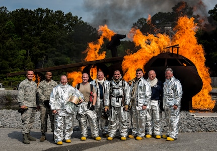 Col. Jeffrey DeVore, Joint Base Charleston commander, Navy Capt. Timothy Sparks, JB Charleston deputy commander, Master Chief Petty Officer Joseph Gardner, Naval Support Activity command master chief, and Chief Master Sgt. Mark Bronson, 628th Air Base Wing command chief, visited the 628th Civil Engineer Squadron Fire Department where they trained on an aircraft simulator April 27, 2014, at the JB Charleston Fire Department. The 628th Air Base Wing leadership visit units as part of a program designed to give base leaders a taste of what Airmen and Sailors do at their job centers every day. (U.S. Air Force photo/ Senior Airman Dennis Sloan)