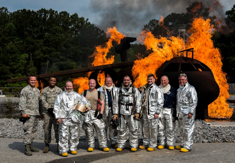 Col. Jeffrey DeVore, Joint Base Charleston commander, Navy Capt. Timothy Sparks, JB Charleston deputy commander, Master Chief Petty Officer Joseph Gardner, Naval Support Activity command master chief, and Chief Master Sgt. Mark Bronson, 628th Air Base Wing command chief, visited the 628th Civil Engineer Squadron Fire Department where they trained on an aircraft simulator April 27, 2014, at the JB Charleston Fire Department. The 628th Air Base Wing leadership visit units as part of a program designed to give base leaders a taste of what Airmen and Sailors do at their job centers every day. (U.S. Air Force photo/ Senior Airman Dennis Sloan)