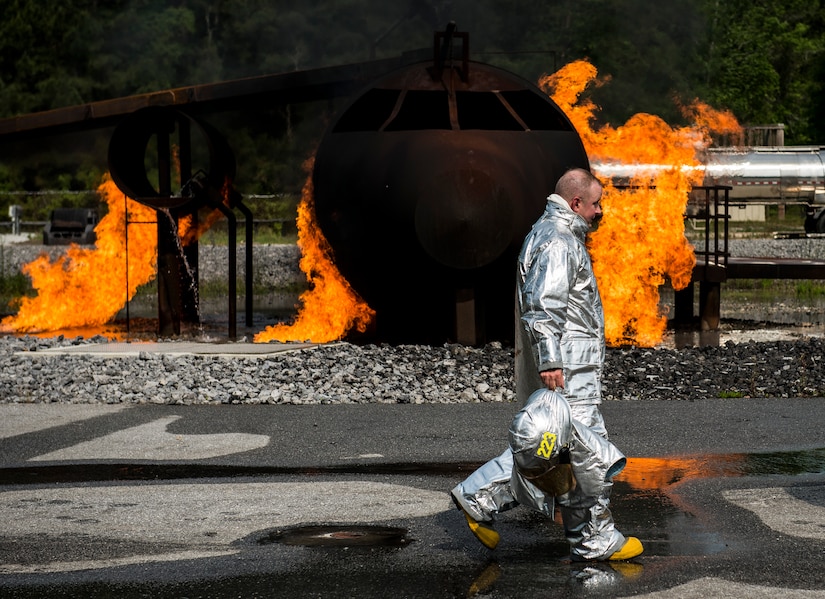 Col. Jeffrey DeVore, Joint Base Charleston commander, walks away from an aircraft simulator April 27, 2014, at the JB Charleston Fire Department. DeVore, Navy Capt. Timothy Sparks, JB Charleston deputy commander, Master Chief Petty Officer Joseph Gardner, Naval Support Activity command master chief, and Chief Master Sgt. Mark Bronson, 628th ABW command chief, visit units as part of a program designed to give base leaders a taste of what Airmen and Sailors do at their job centers every day. (U.S. Air Force photo/ Senior Airman Dennis Sloan)