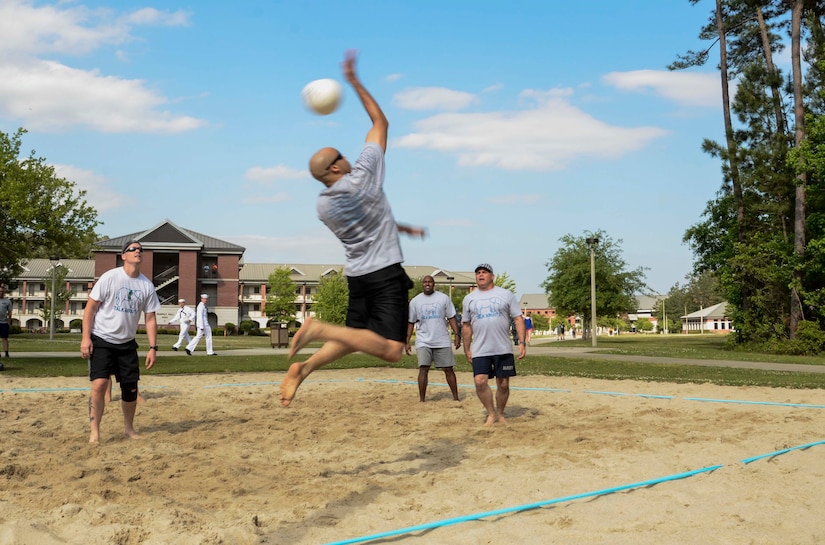 Lieutenent Adrian Jones, Naval Support Activity supply officer (center) and member of the NSA Allstars, competes in a 42-team beach volleyball tournament along side teammates (left to right) Lt. j.g. Pete McLaughlin, NSA Admin officer, Senior Chief Petty Officer Vince Stephens, 628th Security Forces Squadron and Capt. Timothy Sparks, Joint Base Charleston deputy commander April 25, 2014 at the Naval Nuclear Power Training Command campus on JB Charleston - Weapons Station. The annual tournament helps raise awareness for Sexual Assault Prevention and Response Program during Sexual Assault Awareness Month. (U.S. Navy photo/Petty Officer 3rd Class Jason Pastrick)