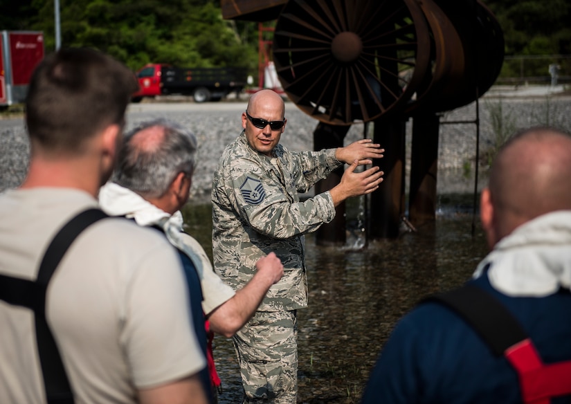 Master Sgt. Craig Spears, 628th Civil Engineer Squadron Fire Department assistant chief of training, instructs base leadership on what to expect during fire-pit training during a 628th Air Base Wing leadership visit April 27, 2014, at the JB Charleston Fire Department. Col. Jeffrey DeVore, JB Charleston commander, Capt. Timothy Sparks, JB Charleston deputy commander, Master Chief Petty Officer Joseph Gardner, Naval Support Activity command master chief, and Chief Master Sgt. Mark Bronson, 628th ABW command chief, visit units as part of a program designed to give base leaders a taste of what Airmen and Sailors do at their job centers every day. (U.S. Air Force photo/ Senior Airman Dennis Sloan)