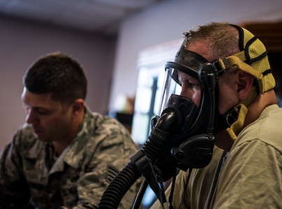 Col. Jeffrey DeVore, Joint Base Charleston commander, undergoes a mask-fit test conducted by Staff Sgt. Anthony Ankeny, 628th Civil Engineer Squadron Fire Department lead fire fighter, during a 628th AB Wing leadership visit April 27, 2014, at the JB Charleston Fire Department. DeVore, Capt. Timothy Sparks, JB Charleston deputy commander, Master Chief Petty Officer Joseph Gardner, Naval Support Activity command master chief, and Chief Master Sgt. Mark Bronson, 628th ABW command chief, visit units as part of a program designed to give base leaders a taste of what Airmen and Sailors do at their job centers every day. (U.S. Air Force photo/ Senior Airman Dennis Sloan)
