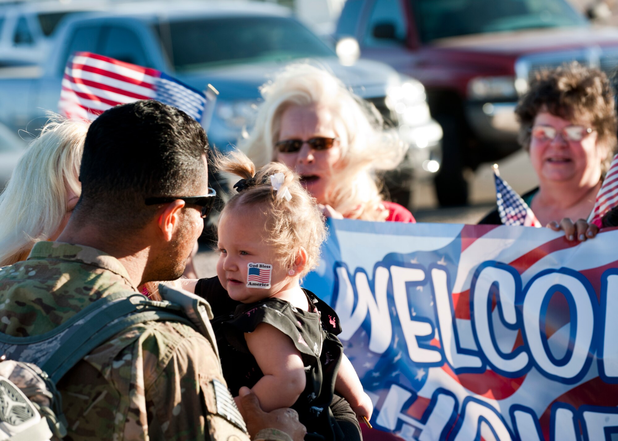 An Airman from the 820th RED HORSE reunites with his family after returning from deployment April 28, 2014, at Nellis Air Force Base, Nev. Approximately 140 820th RED HORSE Airmen are returning from a seven month deployment in southwest Asia. (U.S. Air Force photo by Airman 1st Class Thomas Spangler)