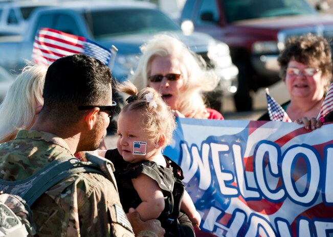 An Airman from the 820th RED HORSE reunites with his family after returning from deployment April 28, 2014, at Nellis Air Force Base, Nev. Approximately 140 820th RED HORSE Airmen are returning from a seven month deployment in southwest Asia. (U.S. Air Force photo by Airman 1st Class Thomas Spangler)