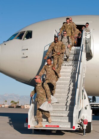Airmen from the 820th RED HORSE disembark a Boeing 767-300ER returning from deployment April 28, 2014, at Nellis Air Force Base, Nev.  The Airmen were returning from a seven month deployment in southwest Asia. (U.S. Air Force photo by Airman 1st Class Thomas Spangler)