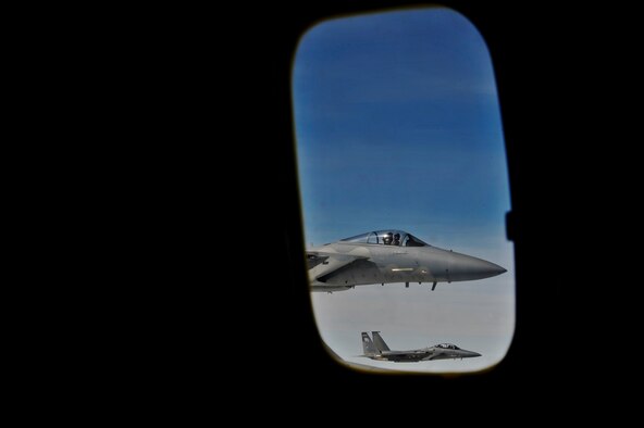 Two Air National Guard F-15 Eagles from the 173rd Fighter Wing fly away after receiving fuel from a 92nd Air Refueling Wing KC-135 Stratotanker during an incentive flight over Oregon, April 25, 2014. (U.S. Air Force Photo by Staff Sgt. Alexandre Montes/Released)