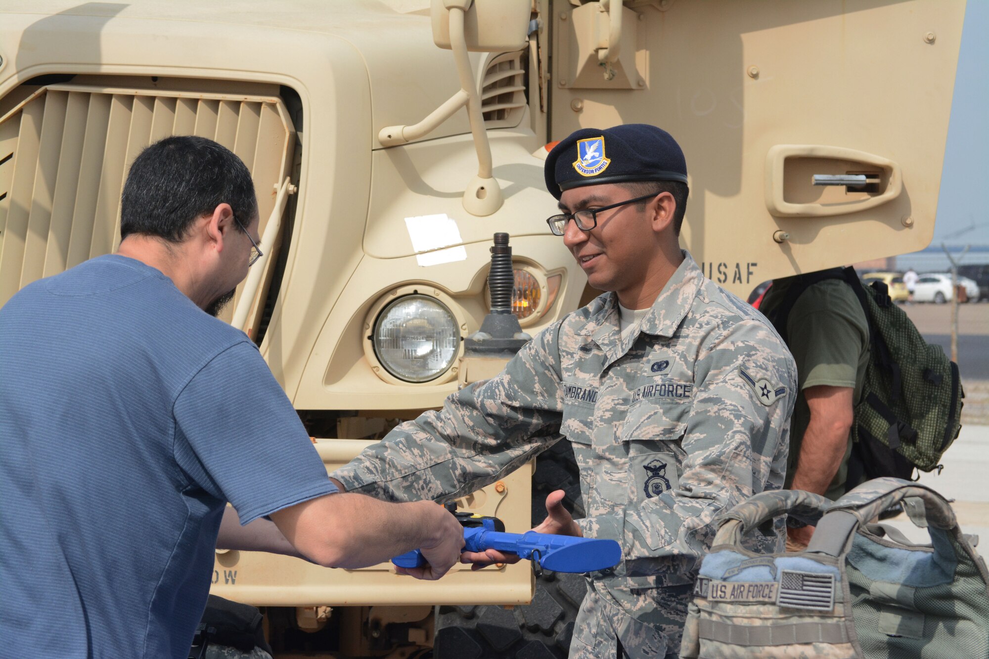 Airman Pedro Zambrano, 610th Security Forces Squadron, speaks with patrons during the 2014 Air Power Expo at Naval Air Station Fort Worth Joint Reserve Base, Texas. Saturday's total attendance was a single-day air show record for NAS Fort Worth JRB. (U.S. Air Force photo/Staff Sgt. Samantha Mathison)