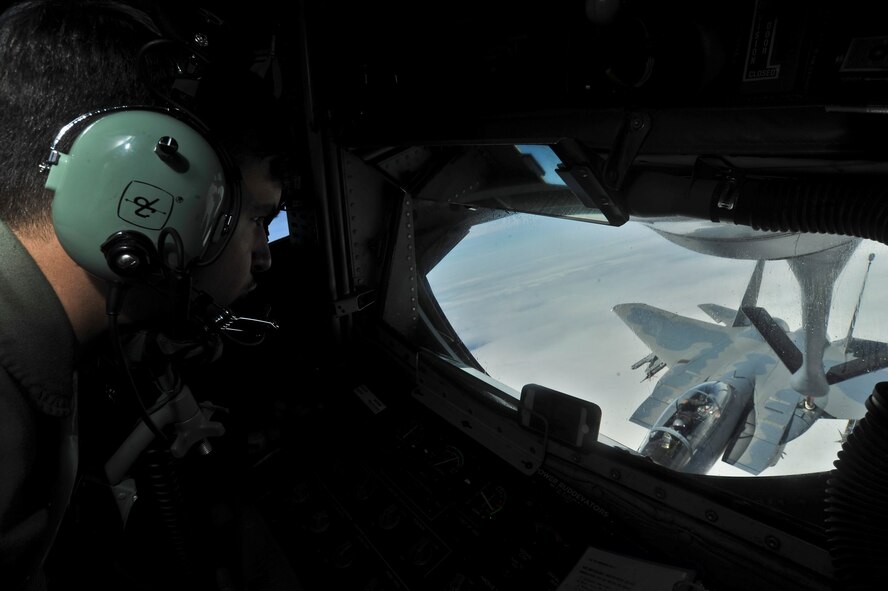 Airman 1st Class Davis Gese refuels an Air National Guard F-15 Eagle from the 173rd Fighter Wing during an incentive flight over Oregon, April 25, 2014. The Honorary Commanders and Eagles program pairs Spokane Civic Leaders with personnel at Fairchild to form a bond and familiarize the community with Fairchild operations fostering mutual understanding and establishing long lasting bonds of friendship. Gese is a 93rd Air Refueling Squadron boom operator. (U.S. Air Force Photo by Staff Sgt. Alexandre Montes/Released)