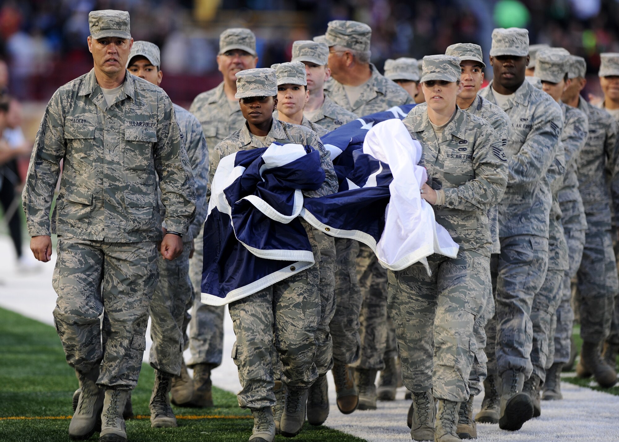 Airmen from Beale and Travis Air Force Bases carry a large American Flag during the opening ceremonies of the inaugural Sacramento Republic FC home game at Hughes Stadium in Sacramento, Calif., April 26, 2014. The newly formed team is a part of the United Soccer Leagues’ Men’s Professional Soccer. (U.S. Air Force photo by Staff Sgt. Robert M. Trujillo/Released)