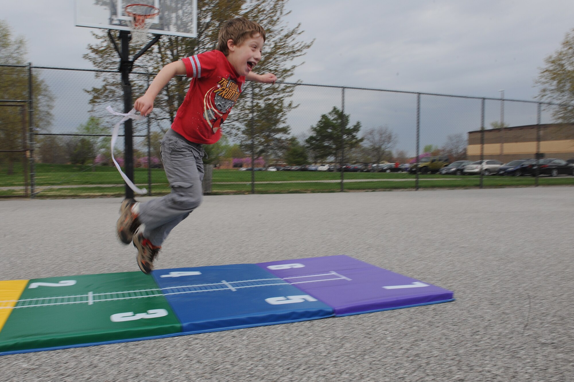 Garret Hacker practices the long jump during a practice session at Scott Air Force Base, Ill., April 23, 2014.  Hacker competed in this event during the Special Olympics, which was held at Southern Illinois University Edwardsville, April 26.  Hacker is the son of ret. Air Force major, Cort Hacker.  (U.S. Air Force photo by Staff Sgt. Maria Bowman)