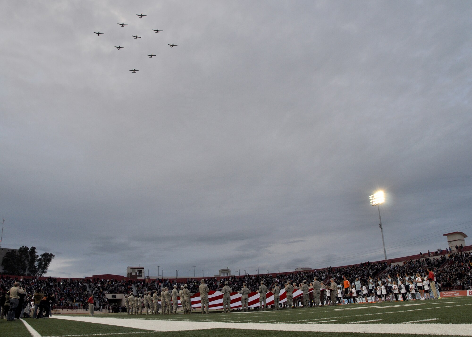 A military-styled fly-over is performed by Nor Cal Beechboys aircraft during the opening ceremonies of the inaugural Sacramento Republic FC home game at Hughes Stadium in Sacramento, Calif., April 26, 2014. Airmen from Beale and Travis Air Force Bases represented the U.S. Armed Forces and presented a large American Flag at mid-field during the ceremonies. (U.S. Air Force photo by Staff Sgt. Robert M. Trujillo/Released)   