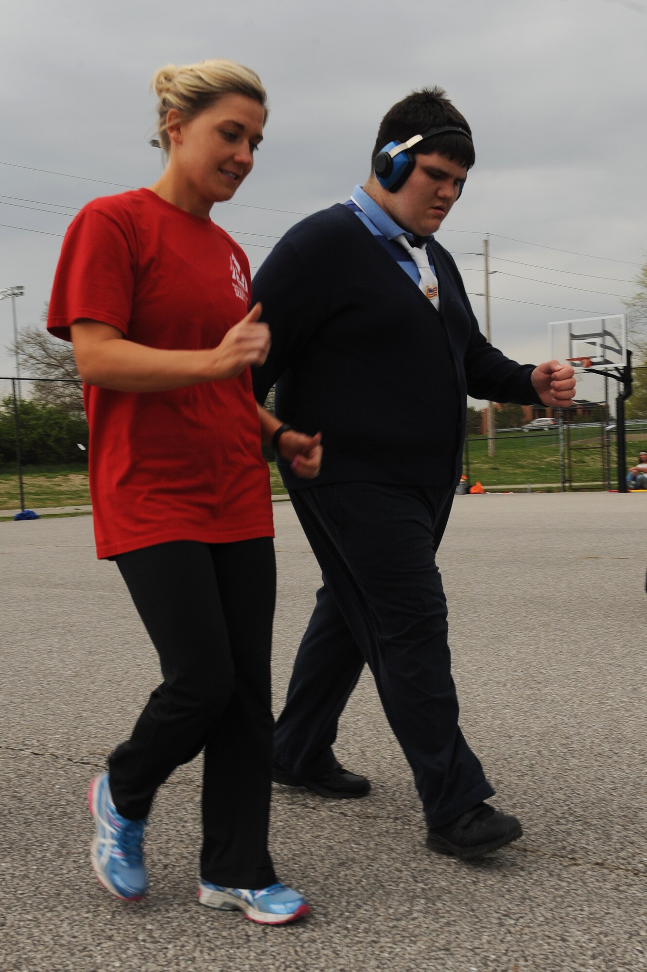 Kayce Beatty, right, encourages Jimmy Howe during a Special Olympics training session at Scott Air Force Base, Ill., April 23, 2014.  Howe competed in a walking challenge and a ball throwing competition, where the goal is to toss a ball further than other participants.  The Special Olympics was held at Southern Illinois University Edwardsville, April 26.  Beatty is a Health and Wellness Center exercise physiologist.  (U.S. Air Force photo by Staff Sgt. Maria Bowman)