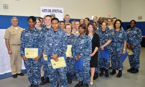Capt. Timothy Sparks, Joint Base Charleston deputy commander (left) and Tiffany Mizzell, Sexual Assault Response Coordinator for JB Charleston Weapons Station (fourth from right), recognize the 32 Sexual Assault Prevention and Response Victim Advocates from the eight Navy Mission partners on JB Charleston and the Citadel’s NROTC unit April 30, 2014, during the Sexual Assault Awareness Month Appreciation Luncheon at the Bowman Center on the Campus of NNPTC on JB Charleston – Weapons Station, S.C. Victim advocates are the military’s first responders to sexual assault reports and are on watch 24/7 to provide support services for adult victims of sexual assault. (U.S. Air Force photo/Eric Sesit)