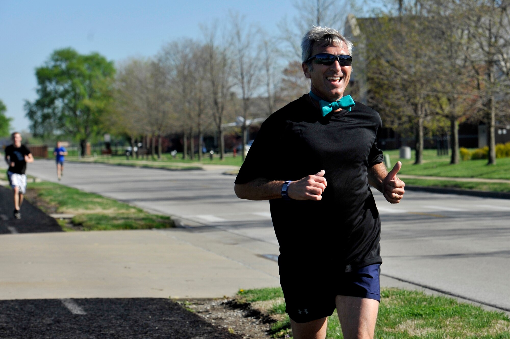 Frank Jones finishes his run during the Sexual Assault Awareness Month 5k run April 25, 2014 at Scott Air Force Base, Ill. Participants wore teal to represent sexual assault awareness and prevention. Medals were also given to fastest female and male, first participant to show up, youngest participant, and many more. (U.S. Air Force photo/ Airman 1st Class Kiana Brothers)